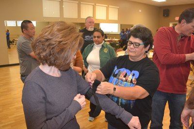 Stop the Bleed participants Susan Delgado and Olivia Madrigal take part in an exercise using tourniquets. 